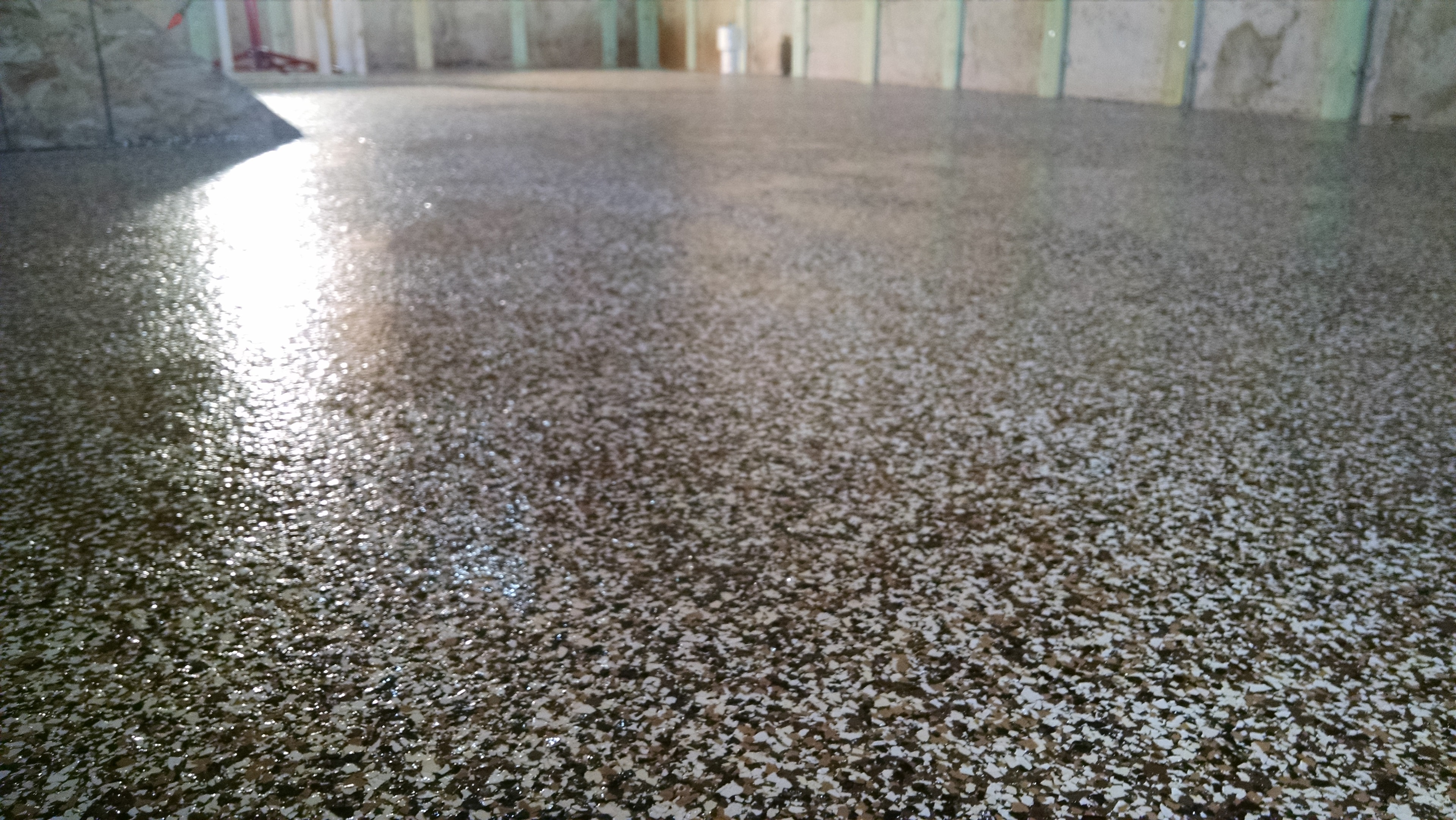 Large commercial flake epoxy floor installation by Expert Concrete Care